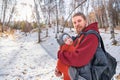 Adorable smiling bearded babywearing father with his baby in sling autumn forest walking Royalty Free Stock Photo