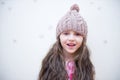 Adorable smiling child girl in beige knitted hat