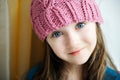 Adorable smiling child girl in pink knitted hat