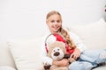 Child with teddy bear with headphones