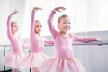 adorable smiling children in pink tutu skirts dancing in ballet