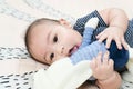 Adorable smiling happy asian baby boy having fun with rabbit doll on play mat. Happy healthy kid playing on floor with mobile Royalty Free Stock Photo