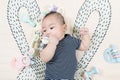 Adorable smiling happy asian baby boy having fun with toys on play mat. Happy healthy kid playing on floor with mobile educational Royalty Free Stock Photo