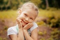 Adorable smiling little blonde girl with braided hair. Cute child having fun on a sunny summer day outdoor.