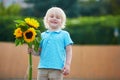 Little boy with bunch of sunflowers outdoors Royalty Free Stock Photo