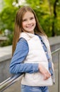 Adorable smiling little girl child preteen standing in the park outdoors Royalty Free Stock Photo