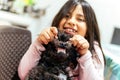 Adorable smiling little girl child schoolgirl holding and playing with pet dog. Best friends. Royalty Free Stock Photo