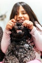Adorable smiling little girl child schoolgirl holding and playing with pet dog. Best friends. Royalty Free Stock Photo