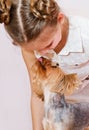 Smiling little girl child schoolgirl holding and playing with pet dog yorkshire terrier Royalty Free Stock Photo