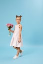 adorable smiling little girl holding bouquet of roses Royalty Free Stock Photo