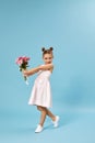 adorable smiling little girl holding bouquet of roses Royalty Free Stock Photo