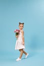 adorable smiling little girl holding bouquet of roses Royalty Free Stock Photo