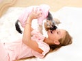 Adorable smiling little girl holding and playing with puppy york Royalty Free Stock Photo