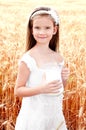 Adorable smiling little girl with milk on field of wheat Royalty Free Stock Photo