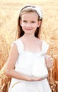 Adorable smiling little girl with milk on field of wheat Royalty Free Stock Photo