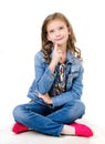 Adorable smiling little girl sitting on a floor