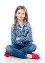 Adorable smiling little girl sitting on a floor
