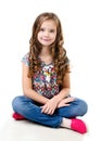 Adorable smiling little girl sitting on a floor isolated