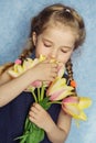 Adorable smiling little girl with tulips