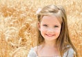 Adorable smiling little girl in the wheat field Royalty Free Stock Photo