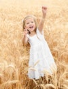 Adorable smiling little girl in the wheat field Royalty Free Stock Photo