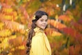 Adorable smiling schoolgirl autumn foliage background. Good mood. Happy child. Enjoying every season. United with nature