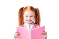 Adorable smiling schoolgirl reading textbook