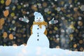 Adorable smiling snowman and blurred Christmas lights on background outdoors. Royalty Free Stock Photo