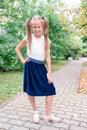 Two cute smilling little girl posing in front of their school. Royalty Free Stock Photo