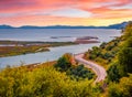 Adorable spring view of Butrint National Park with empty asphalt road.