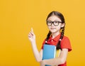 Adorable student girl  holding the books  and showing something Royalty Free Stock Photo