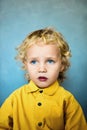 Adorable sweet little boy with golden hair and blue eyes Royalty Free Stock Photo