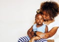 adorable sweet young afro-american mother with cute little daugh