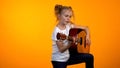Adorable teen girl pretending playing guitar, dream to become famous rock star Royalty Free Stock Photo