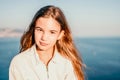 Adorable teenage girl outdoors enjoying sunset at beach on summer day. Close up portrait of smiling young romantic Royalty Free Stock Photo