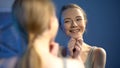 Adorable teenage girl smiling at mirror reflection, feeling cheerful and happy Royalty Free Stock Photo