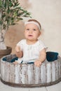 Adorable Ten month old newborn baby girl sitting in a wooden bucket. old baby in bedroom. father's day. father and daughter Royalty Free Stock Photo