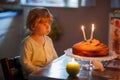 Adorable three year kid boy celebrating birthday and blowing can Royalty Free Stock Photo