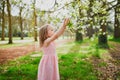 Adorable three year old girl in pink dress enjoying sunny spring day in Park of Sceaux near Paris Royalty Free Stock Photo