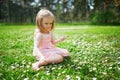 Adorable three year old girl in pink dress enjoying sunny spring day in Park of Sceaux near Paris Royalty Free Stock Photo