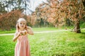 Adorable three year old girl in pink dress enjoying sunny spring day in Park of Sceaux near Paris Royalty Free Stock Photo