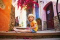 Adorable three years old girl sitting on a street of beautiful Mediterranean town Collioure in France Royalty Free Stock Photo