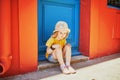 Adorable three years old girl sitting on a street of beautiful Mediterranean town Collioure in France Royalty Free Stock Photo