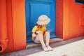 Adorable three years old girl sitting on a street of beautiful Mediterranean town Collioure in France Royalty Free Stock Photo