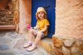 Adorable three years old girl sitting on a street of beautiful Mediterranean town Collioure in France Royalty Free Stock Photo