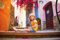 Adorable three years old girl sitting on a street of beautiful Mediterranean town Collioure in France Royalty Free Stock Photo