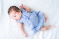 Adorable tiny newborn baby girl in a blue dress