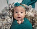 Baby girl in teal with feeding tube