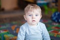 Adorable toddler with blue eyes indoor Royalty Free Stock Photo