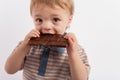 Adorable toddler boy eating a plate of chocolate Royalty Free Stock Photo